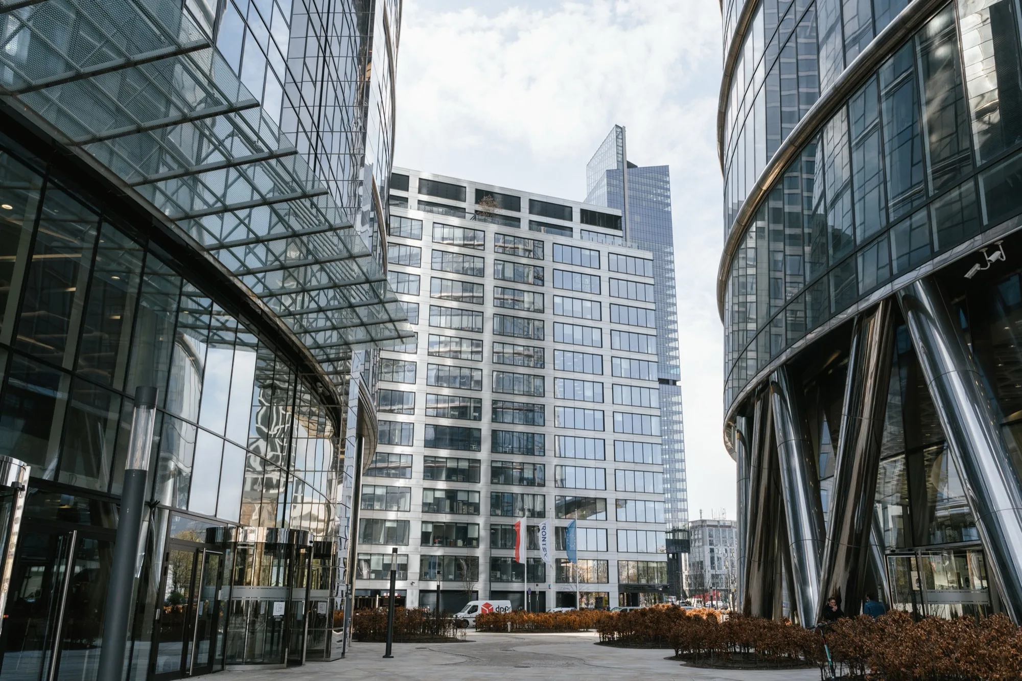 Modern glass office towers around a city plaza